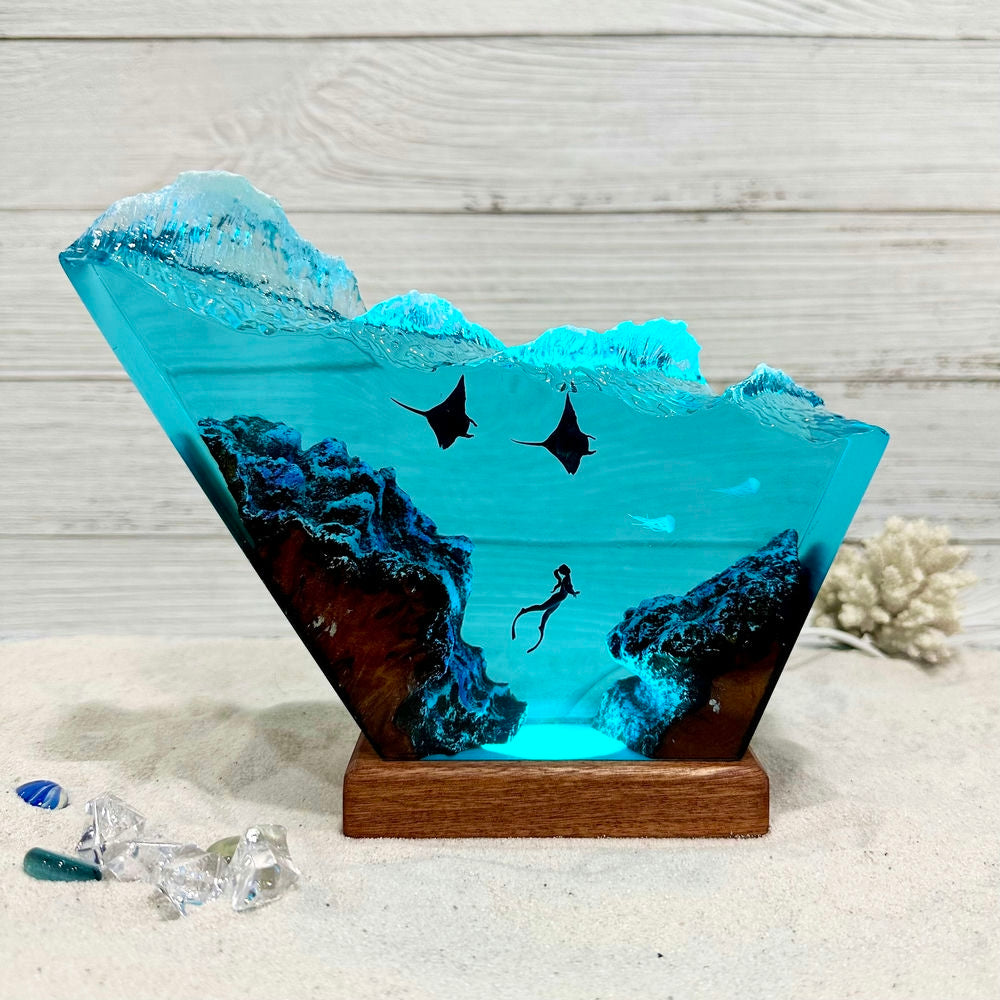 Manta rays under the crashing waves